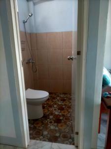 a bathroom with a toilet and a shower at Dhong and Eden Home in San Vicente