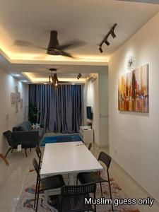 a living room with a white table and a couch at QAISARA D'SAVANNA HOMESTAY@SOUTHVILLE CITY in Bangi