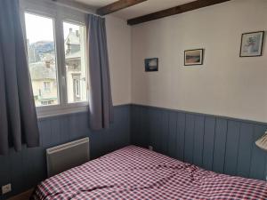 um quarto com uma cama e uma janela em Appartement Mont-Dore, 3 pièces, 4 personnes - FR-1-415-145 em Le Mont-Dore
