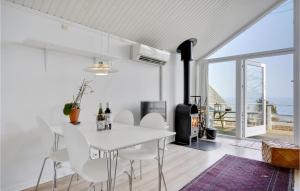 a white dining room with a white table and chairs at Cozy Home In Snekkersten With Kitchen in Snekkersten