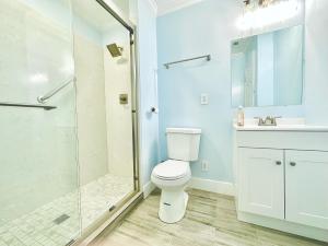 a bathroom with a toilet and a glass shower at 3 bedroom residential home in the lovely town near SFO San Francisco in Millbrae