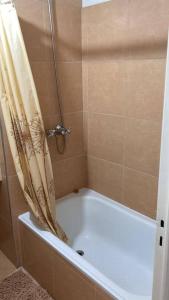 a bath tub with a shower curtain in a bathroom at TORRES H in Córdoba