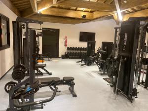 a gym with several treadmills and machines in a room at Apartamento Praia do Forte in Mata de Sao Joao