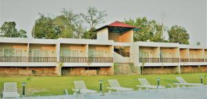 a building with white chairs in front of it at Kumbhal Exotica Resort Kumbhalgarh in Kumbhalgarh