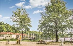 un parque con parque infantil junto a un lago en 2 Bedroom Lovely Home In Rekem-lanaken en Bovenwezet