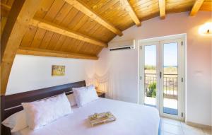 a bedroom with a white bed and a balcony at Casa Loughry in Badolato