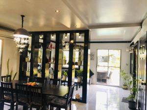 a dining room with a table and chairs at Panglao Bed and Breakfast Exclusive Villa in Panglao