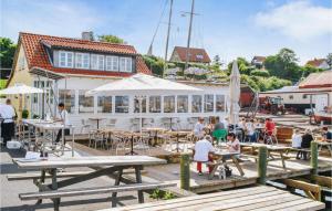 un grupo de personas sentadas en mesas en un muelle en 4 Bedroom Cozy Home In Nykbing Sj en Ebbeløkke