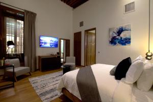 TV a/nebo společenská místnost v ubytování Nueve 25 Hotel Boutique