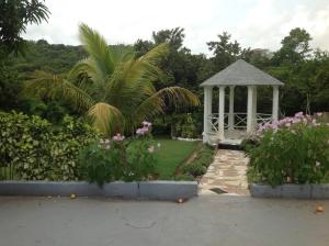 a gazebo in the middle of a garden at Hibiscus Cottage in Belle Air Summit