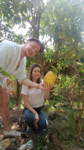 a man and a woman holding a piece of corn at Sigiriya Nature View home Stay in Sigiriya