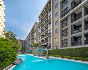 a swimming pool in front of a building at Pool View Marvest Huahin by Wilmot in Hua Hin