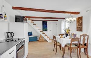 a kitchen and dining room with a table and chairs at 1 Bedroom Pet Friendly Apartment In Nrre Alslev in Nørre Alslev