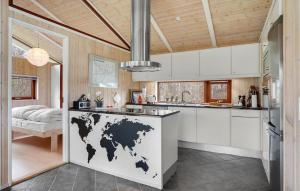 a kitchen with a map of the world on the counter at Nice Home In Grenaa With Sauna in Grenå