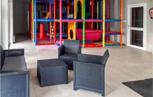 a childrens play area with chairs and a playground at 1 Bedroom Stunning Apartment In Mielno in Mielno