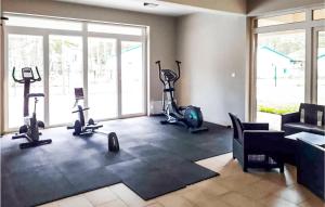 a fitness room with treadmills and exercise bikes at 1 Bedroom Stunning Apartment In Mielno in Mielno
