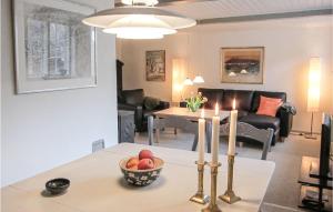 a living room with a table with a bowl of fruit at Beautiful Home In Gudhjem With 2 Bedrooms And Wifi in Gudhjem