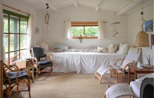 a bed in a room with chairs and a window at Stunning Home In Anholt With Wifi in Anholt