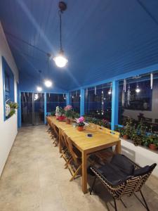 a long wooden table and chairs in a room at Pensiunea Delta Blue in Maliuc