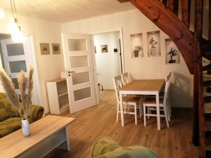 a kitchen and dining room with a table and chairs at Apartman Deluxe Cheb in Cheb