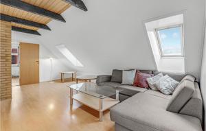a living room with a couch and a table at Stunning Home In Østermarie With Wifi in Østermarie