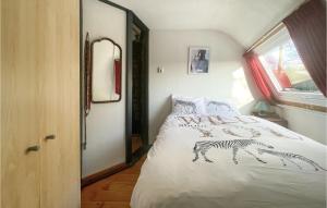 a bedroom with a bed with zebra drawings on it at 2 Bedroom Stunning Home In Chaam in Chaam