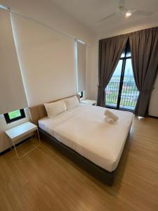 a bedroom with a large white bed and a window at Imperio Professional Suite by 188AOR in Alor Setar