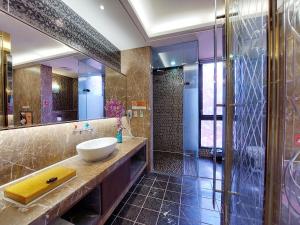 a bathroom with a sink and a shower at Elysees Motel in Toufen