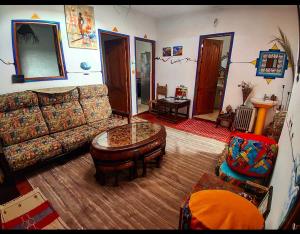 a living room with a couch and a coffee table at Hippie Chic Room 3 in Sidi Kaouki