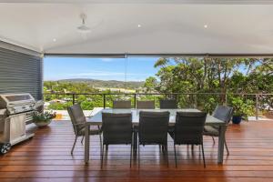 a dining room with a table and chairs on a deck at Copacabana 'Chill Out' in Copacabana