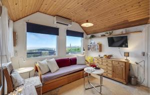 a living room with a couch and a tv at Amazing Home In Esbjerg V With House Sea View in Esbjerg