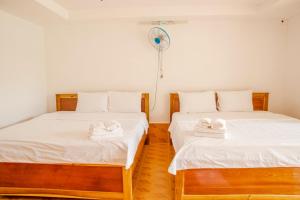 Postel nebo postele na pokoji v ubytování Thiên Tân Hotel
