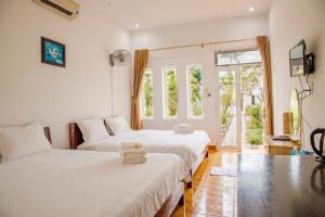 Postel nebo postele na pokoji v ubytování Thiên Tân Hotel