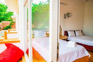 Postel nebo postele na pokoji v ubytování Thiên Tân Hotel