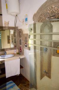 a bathroom with a shower and a sink at Rischland Villas in Watamu