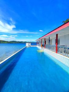 a swimming pool in the water next to a building at Coron Underwater Garden Resort in Coron