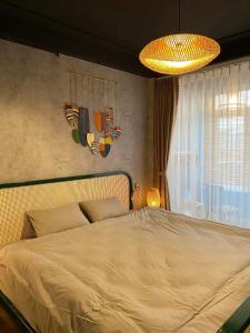 a bedroom with a large bed and a chandelier at Homestay Casa 69 in Hanoi