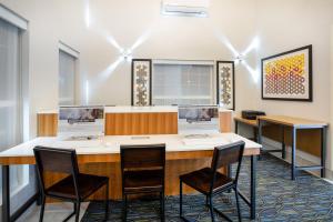 a meeting room with chairs and a desk with a computer at Holiday Inn Express & Suites Lincoln City by IHG in Lincoln City