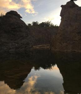 a reflection of the sky in a body of water at Little bungalow Holiday Home, Coorg in Somvārpet