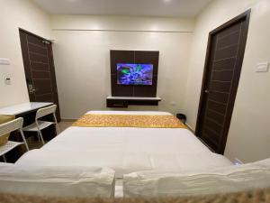 Voodi või voodid majutusasutuse Le Shiv Executive Suite toas