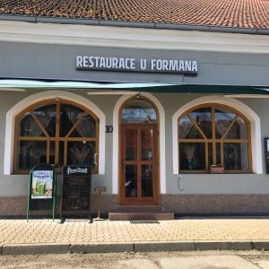 a restaurant with a sign in the front of a building at Penzion u Formana in Stráž nad Nežárkou