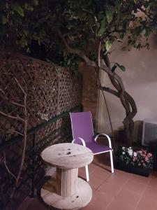 a purple chair and a table next to a tree at Heraklion modern studio 40 sq.m. near town center. in Heraklio