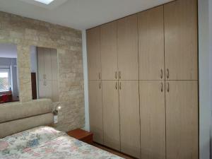 a bedroom with wooden cabinets and a bed at Heraklion modern studio 40 sq.m. near town center. in Heraklio