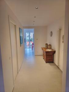 a hallway with a wooden desk in a room at Casa Anelita in La Spezia +3 photos