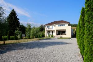 a white house with a driveway in front of it at Villa Terrasse in Eger