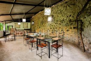 a large room with a table and chairs in it at River Edge Eco Resort in Kitulgala