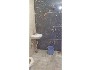 a bathroom with a toilet and a sink at Hotel Prem Sagar, Agra Cantt in Agra