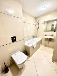 a white bathroom with a toilet and a sink at Forest View Silver M B34 Poiana Brasov in Poiana Brasov