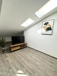 a living room with a flat screen tv on a wall at Forest View Silver M B34 Poiana Brasov in Poiana Brasov