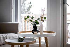 a living room with a table with a vase on it at New lakehouse - amazing sea view and private pier! in Stockholm